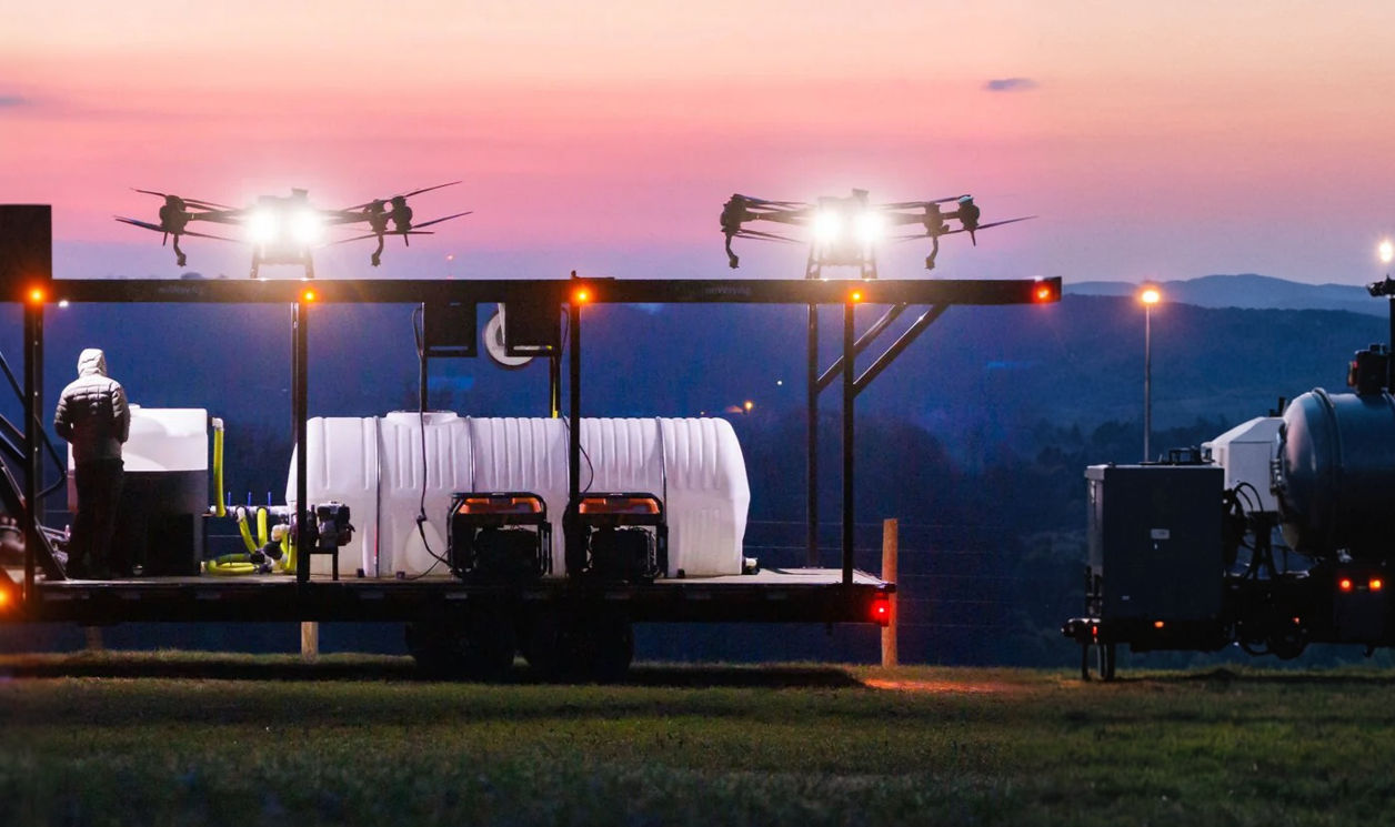 Drone platform at dusk with drones taking off